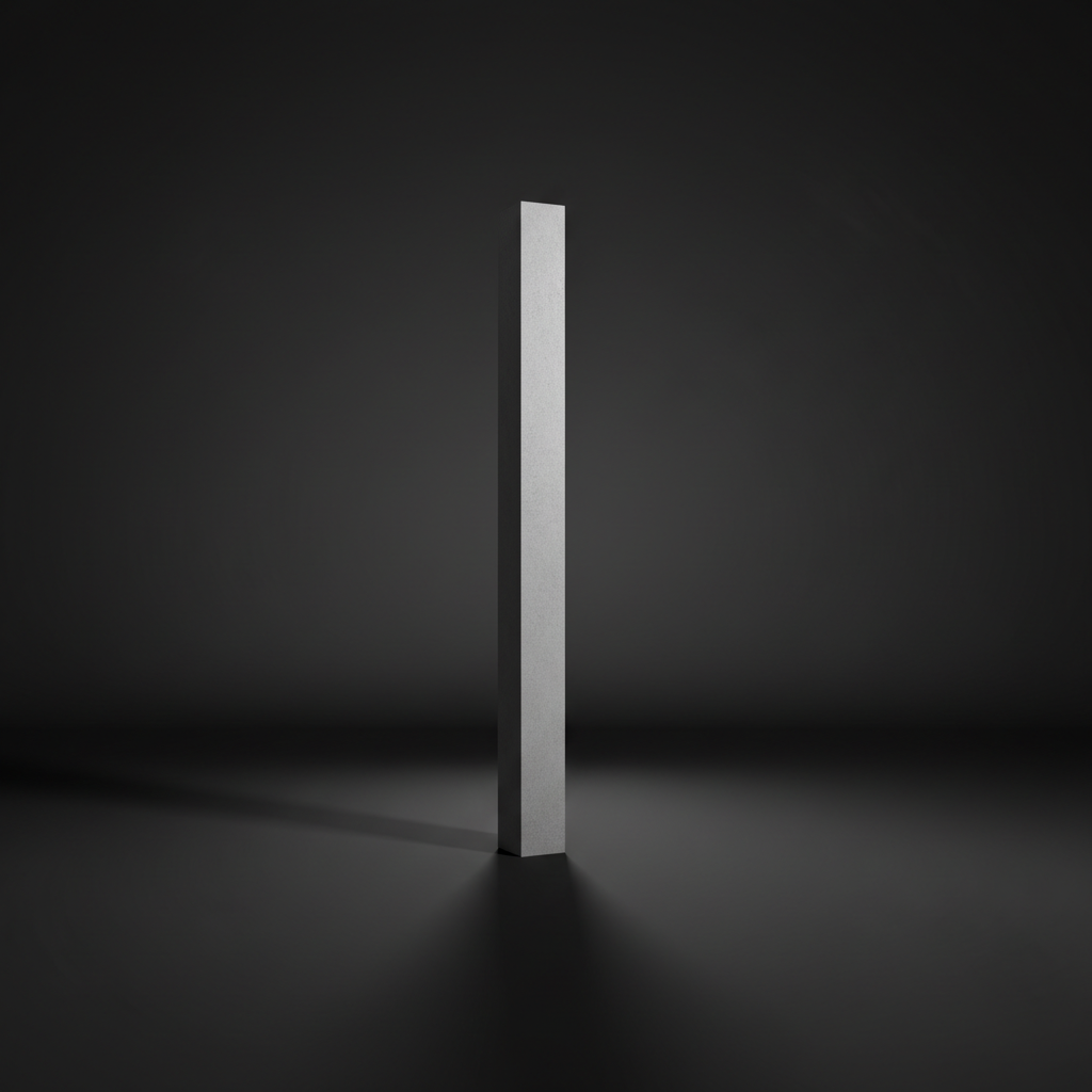 A slender, sandblasted concrete pillar with a smooth finish and light grey tone, standing upright on a matte black floor in a featureless room. Intense side lighting casts a long, crisp shadow across the floor, defining the pillar’s profile with sharp clarity. The minimalist environment is softly blurred into dark gradients, drawing all attention to the pillar’s clean verticality, symbolizing inner growth and support. Photographed from a slightly elevated, diagonal viewpoint, the image creates a sense of depth and rising energy. The overall mood is bold and aspirational, with a modern, photographic style that embodies focused personal evolution.